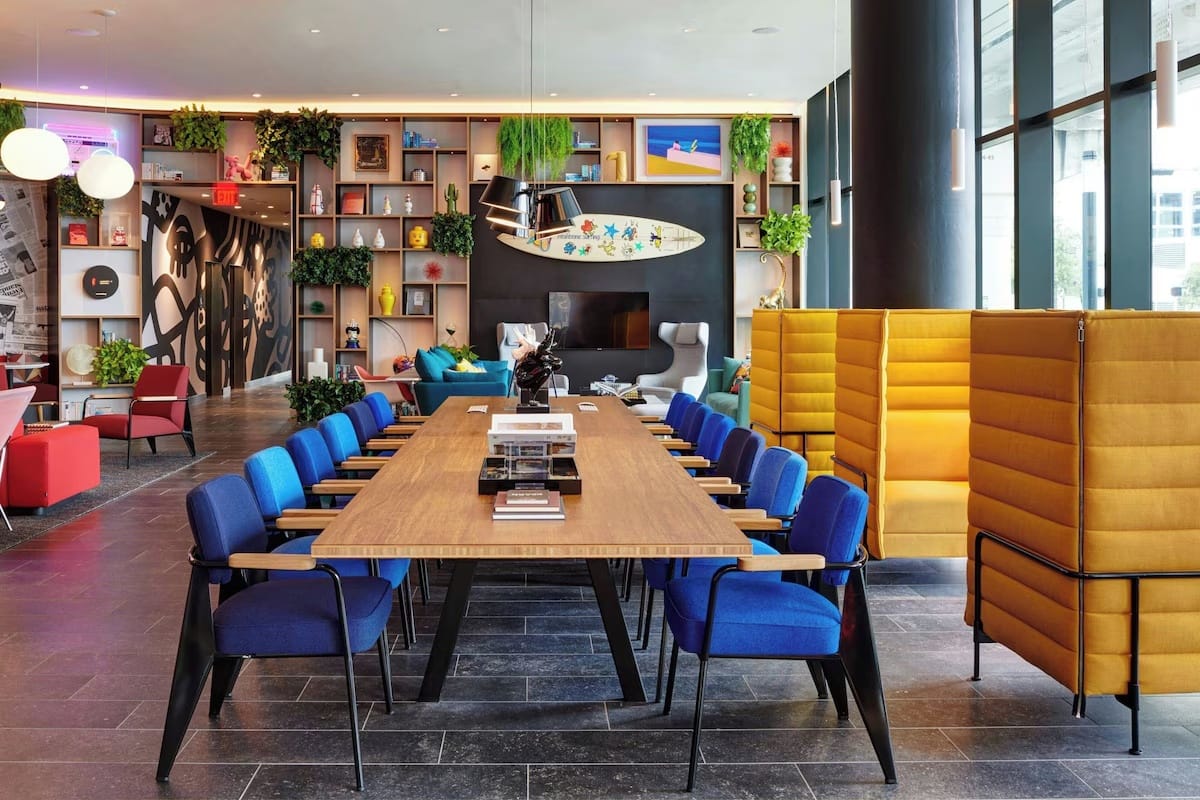 Coworking space at CitizenM Miami Worldcenter, the best hotel in Miami for digital nomads with fast Wi-Fi, quiet work zones, and modern shared work tables.