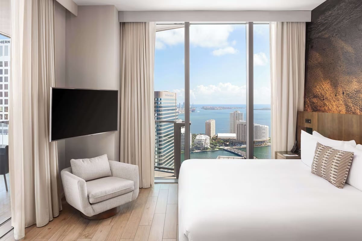 Luxury king room at EAST Miami in Brickell with floor-to-ceiling windows, bay and skyline views, modern minimalist design, and quiet interiors.
