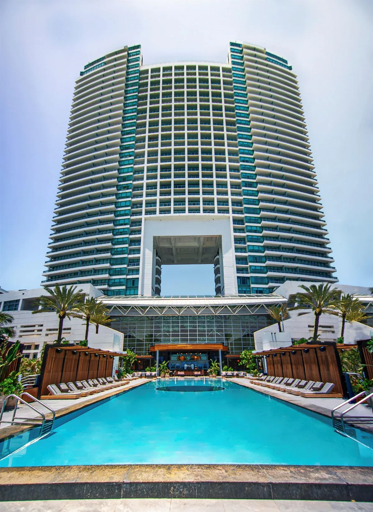 Resort-style pool at The Diplomat hotel lined with cabanas and palm trees near Miami, ideal for 2026 World Cup guests
