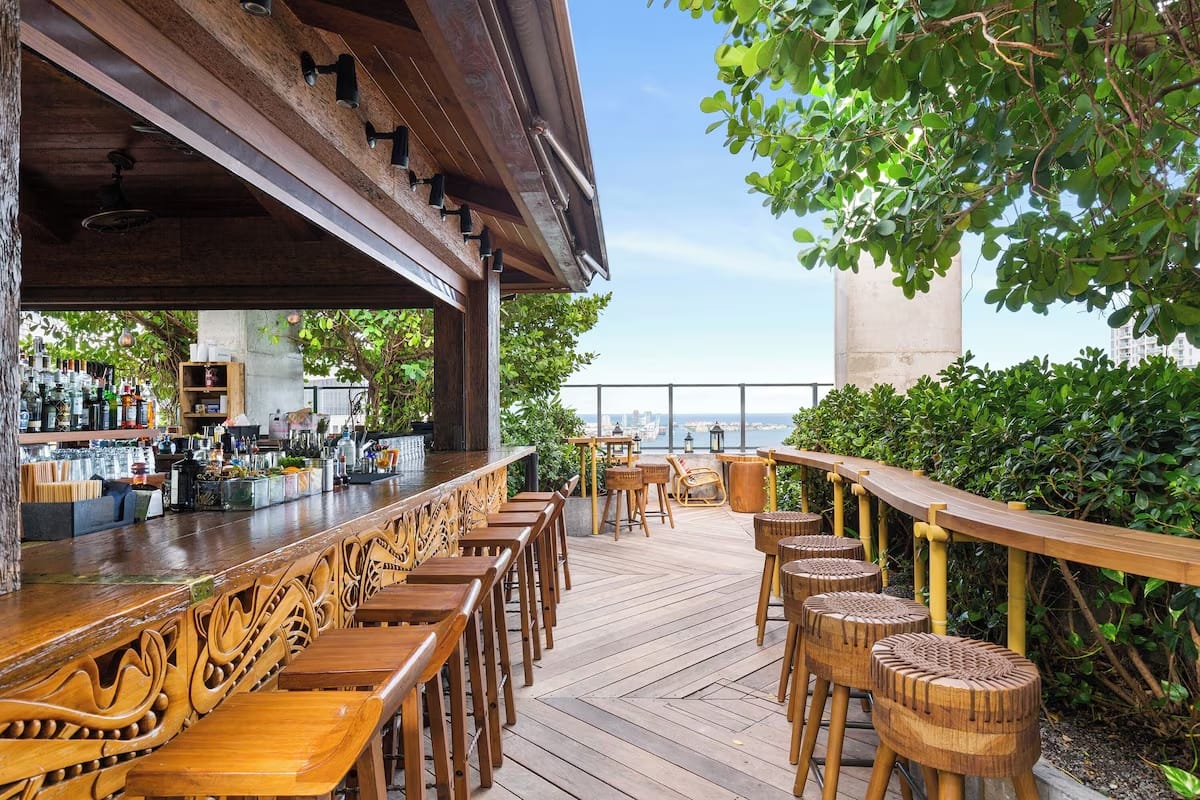 Sugar rooftop bar at EAST Miami in Brickell with skyline views, outdoor lounge seating, cocktails, and sunset nightlife energy.