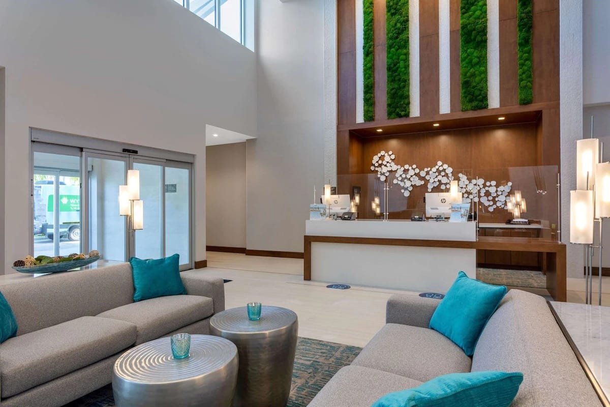 Front desk and check-in area at Wyndham Garden Miami International Airport with accessible layout and modern design.