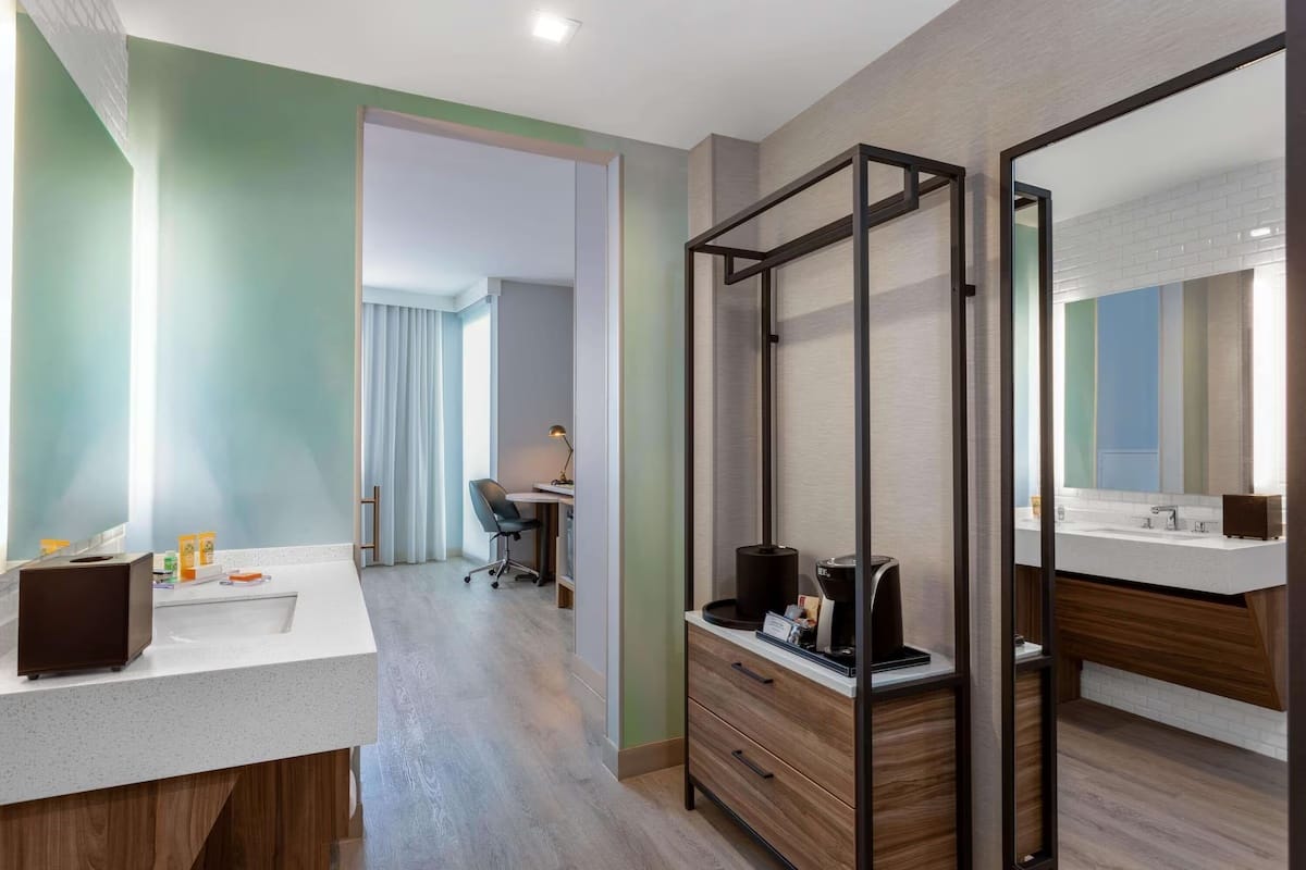 Modern guest room at Wyndham Garden Miami International Airport with workspace, mini fridge, and quiet design for early morning flights.