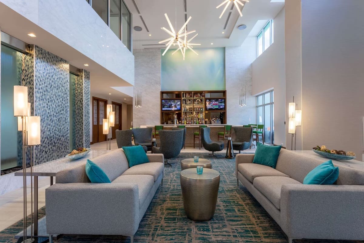 Spacious hotel lobby seating at Wyndham Garden Miami International Airport designed for quiet relaxation before early flights.