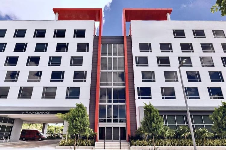 Exterior view of Kompose Boutique Hotel Miami Airport showing modern architecture and entrance.