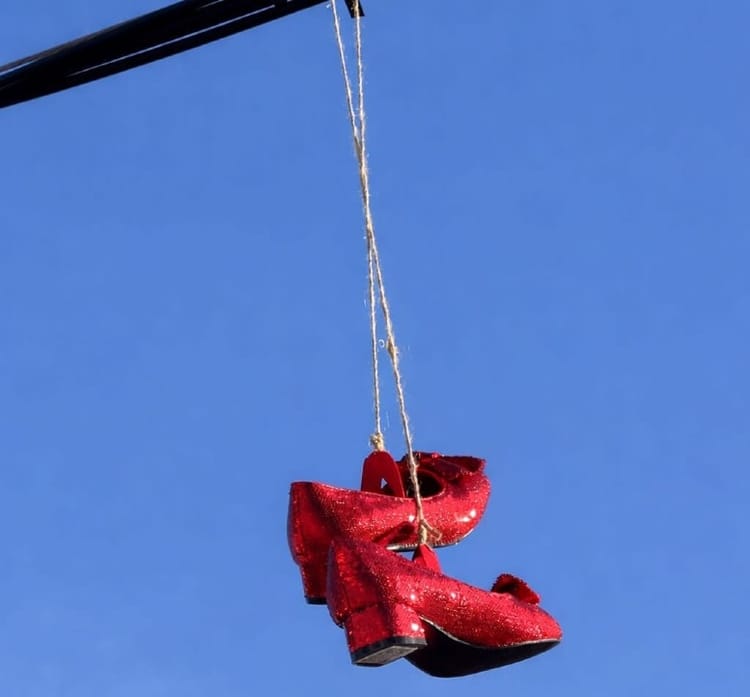 Red shoes street art installation hanging above a street in Wynwood, Miami